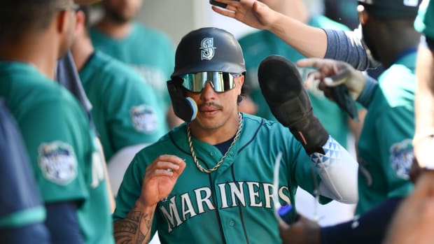 Jul 22, 2023; Seattle, Washington, USA; Seattle Mariners second baseman Kolten Wong (16) celebrates scoring a run against the Toronto Blue Jays in the seventh inning at T-Mobile Park. Mandatory Credit: Steven Bisig-USA TODAY Sports